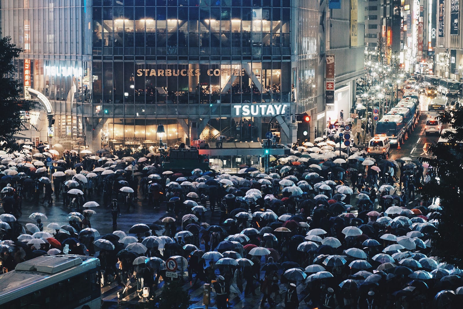 At the Shibuya crossing in Tokyo, hundreds of people crossing at rush hour.